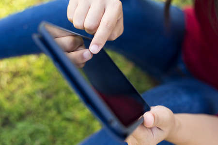 Woman Use Tablet at Parkの写真素材
