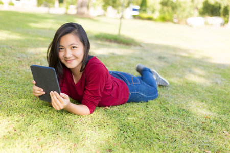 Woman Use Tablet for Relaxation at Park