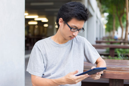 Man Use Tablet on the Bench