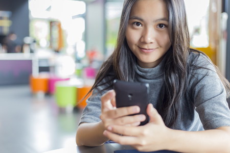 Women Use Smartphone for Business in Cafeの写真素材