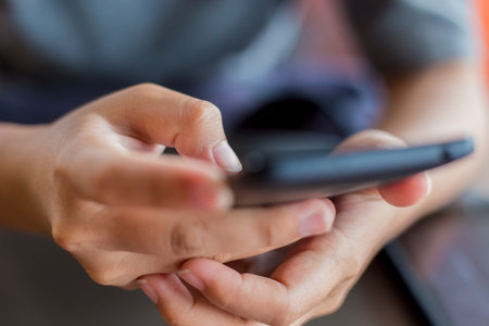 Women Use Smartphone for Business in Cafe