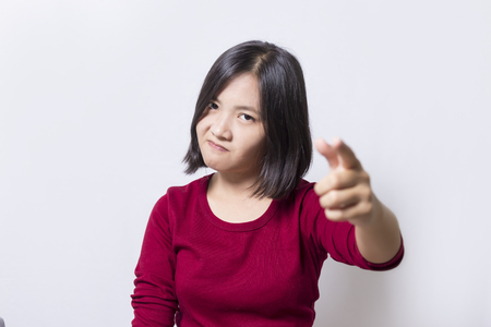 Angry young woman on white backgroundの写真素材
