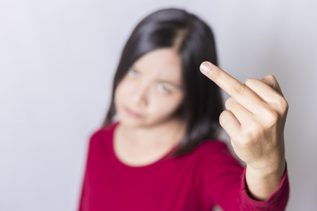 Bad woman is showing fuck off with the middle fingerの写真素材