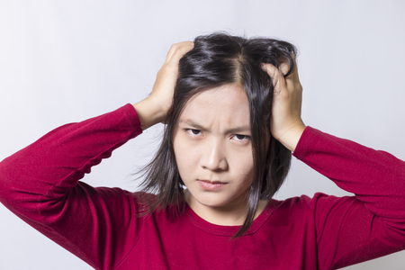 Woman has a headache, isolated on white backgroundの写真素材
