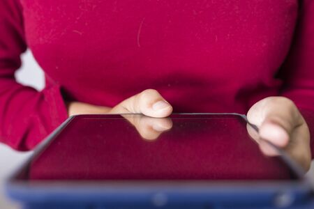 Caucasian woman with tablet on white backgroundの写真素材