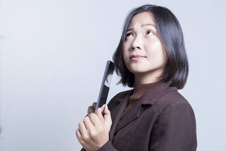 Businesswoman Use Tablet and Thinking: Negative Thinkingの写真素材