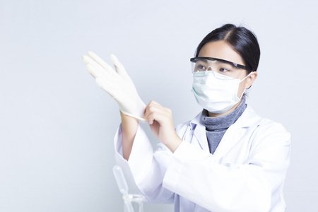 Woman Sciencetist: Getting Dressed for Actionの写真素材