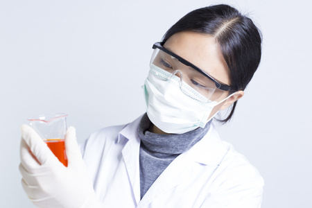 Woman Sciencetist: Researcher Holding at a Liquid Solution on Isolated Backgroundの写真素材