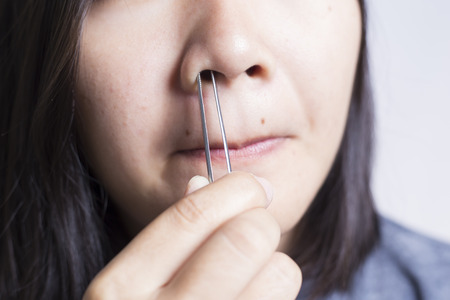 Woman Plucking Her Noseの写真素材