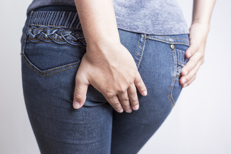 Woman has Diarrhea Holding his Butt: Isolated on White Backgroundの写真素材