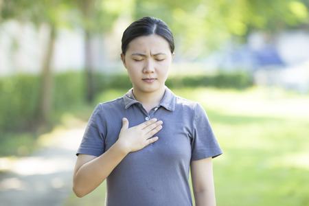 Sore Chest Woman at Parkの写真素材