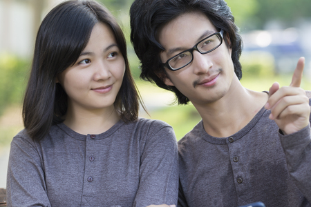 Couple Sit on the Bench at Parkの写真素材