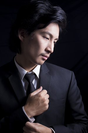 Businessman Fixing Cufflinks his Suitの写真素材