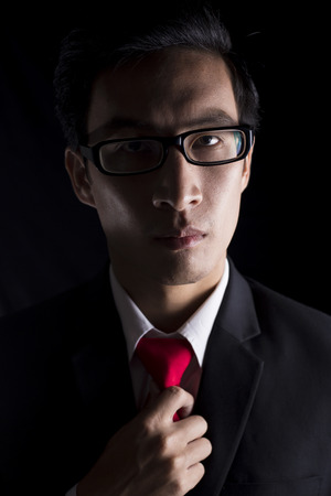 Businessman Adjusting His Necktieの写真素材