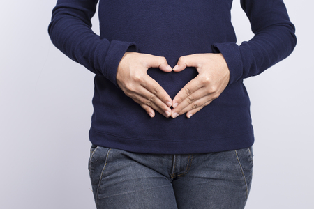Woman Forming Heart Shape on Bellyの写真素材