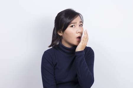 Health Care: Woman checking her breath with her handの写真素材