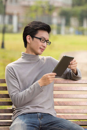 Man use tablet for relaxation at parkの写真素材