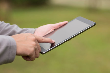 Man use tablet at park
