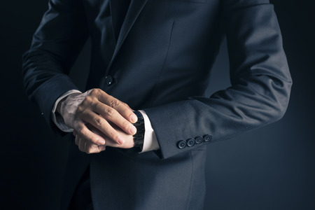 Businessman checking time from watchの写真素材
