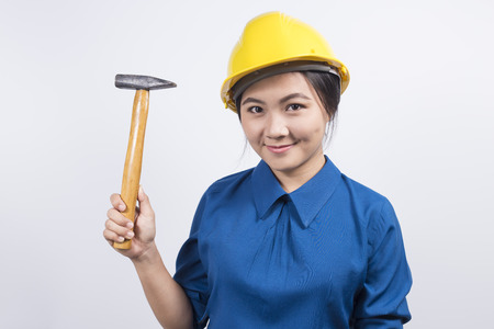 Engineer girl holding a hammerの写真素材