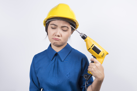 Young builder woman with a drillの写真素材