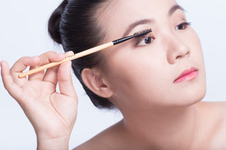 Beauty shot of woman holding the makeup brushの写真素材