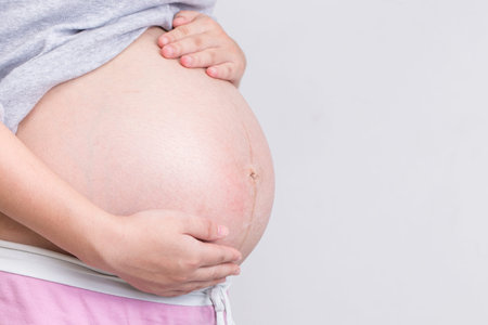 Pregnant woman touching her belly