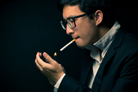 Businessman smoking a cigaretteの写真素材