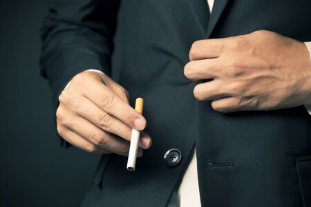 Businessman smoking a cigaretteの写真素材