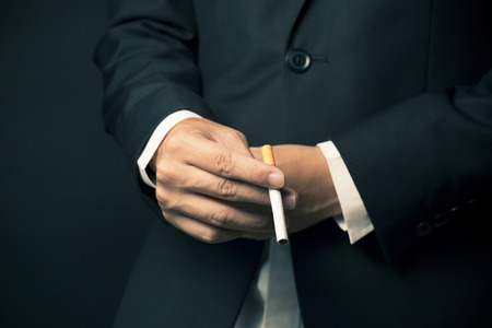 Businessman smoking a cigaretteの写真素材