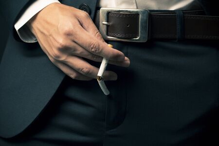 Sexual Dysfunction concept, Businessman smoking a cigaretteの写真素材