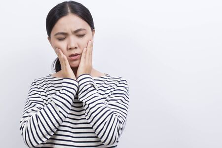 Woman has tooth ache isolated on white backgroundの写真素材