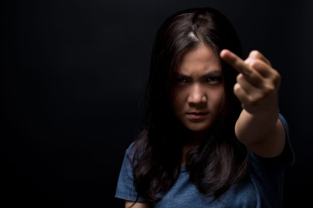 Angry woman show her middle fingerの写真素材