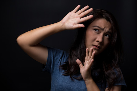 Sad woman on isolated black backgroundの写真素材