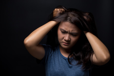 Angry woman on isolated black backgroundの写真素材