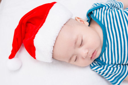 Adorable baby sleeping with hat santa
