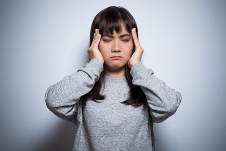 Woman has head ache on isolated background