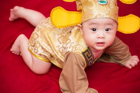 Asian baby in costume king of china cosplayの写真素材