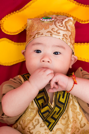Asian baby in costume king of china cosplayの写真素材