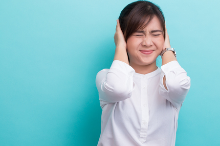 Asian woman close her earsの写真素材