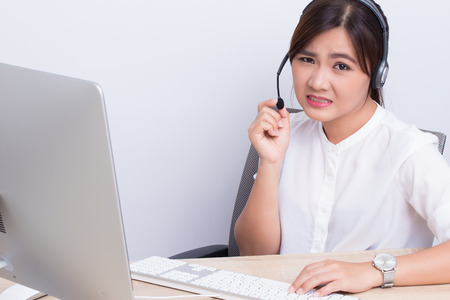Woman working in call center she feel boringの写真素材