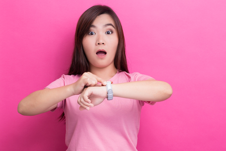 Shy woman check her watch she is lateの写真素材
