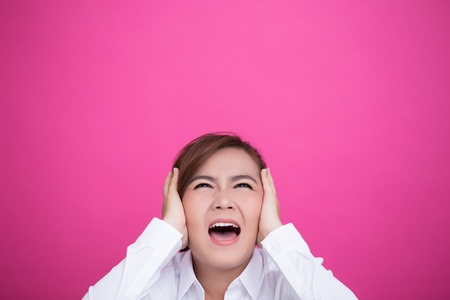 Angry woman screaming out and pulling her hairの写真素材