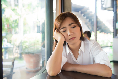 Woman so sad at coffee shopの写真素材