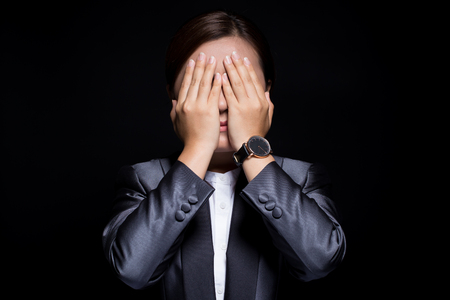 Businesswoman feel scared on isolated black backgroundの写真素材