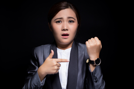 Woman check her watch she is lateの写真素材