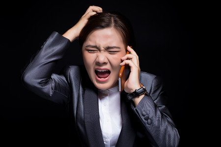 Woman calling the smartphone and she feel angryの写真素材