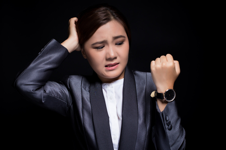 Woman check her watch she is lateの写真素材
