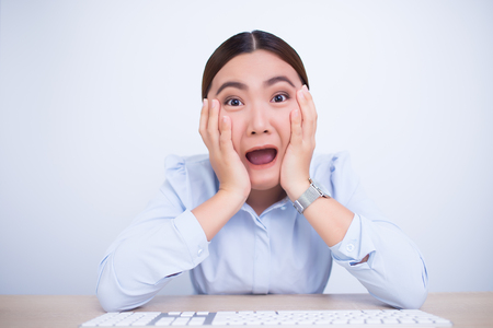 Angry woman screaming out and pulling her hairの写真素材