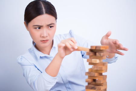 Woman be careful to build a tower puzzleの写真素材